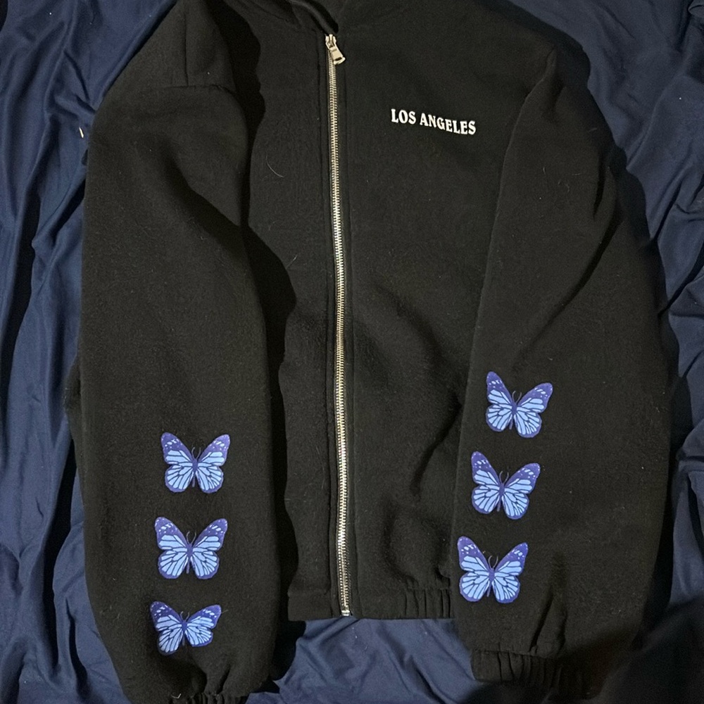 Large hoodie with butterfly sleeves and beat design in the back.